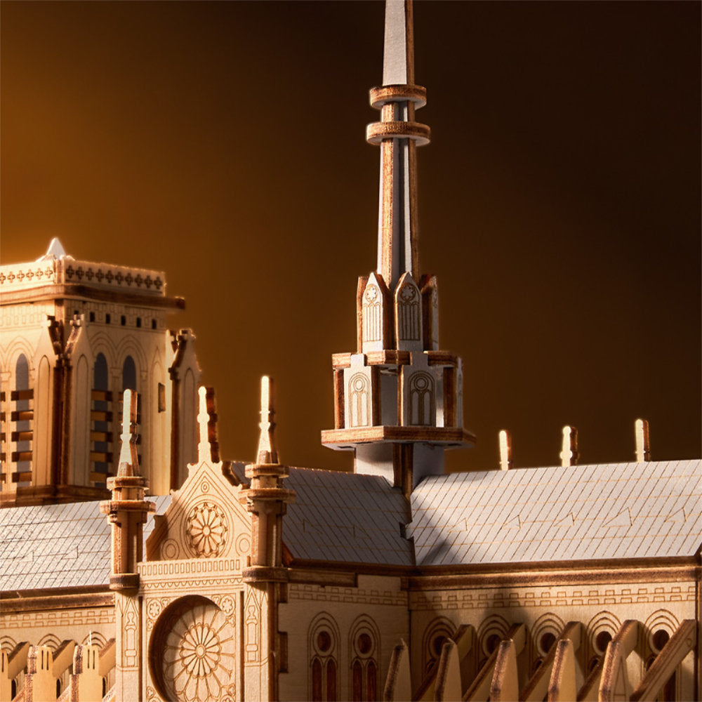 Close-up of a detailed architectural model with a spire against a dark background