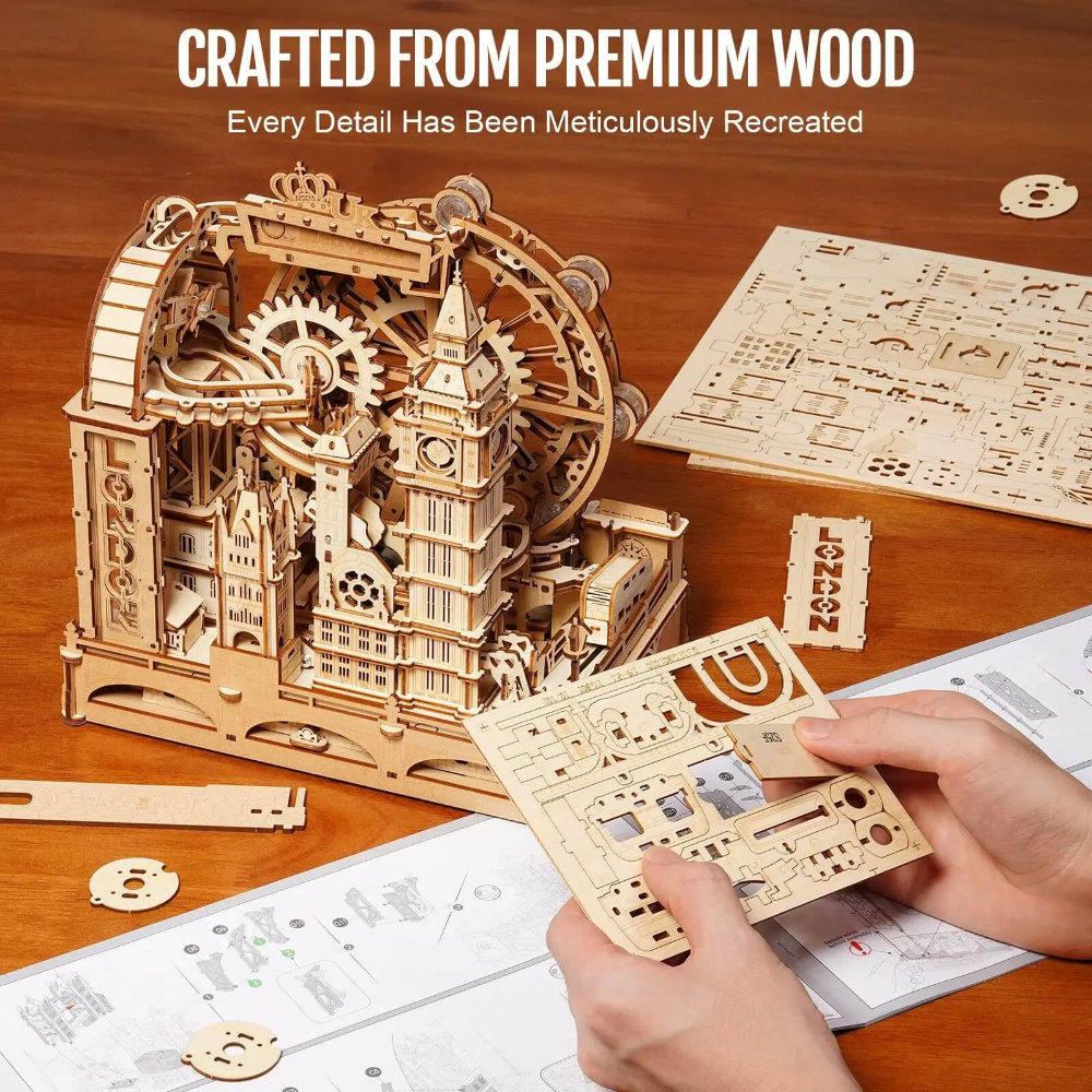 Wooden mechanical model kit on a wooden table with instructions and components.