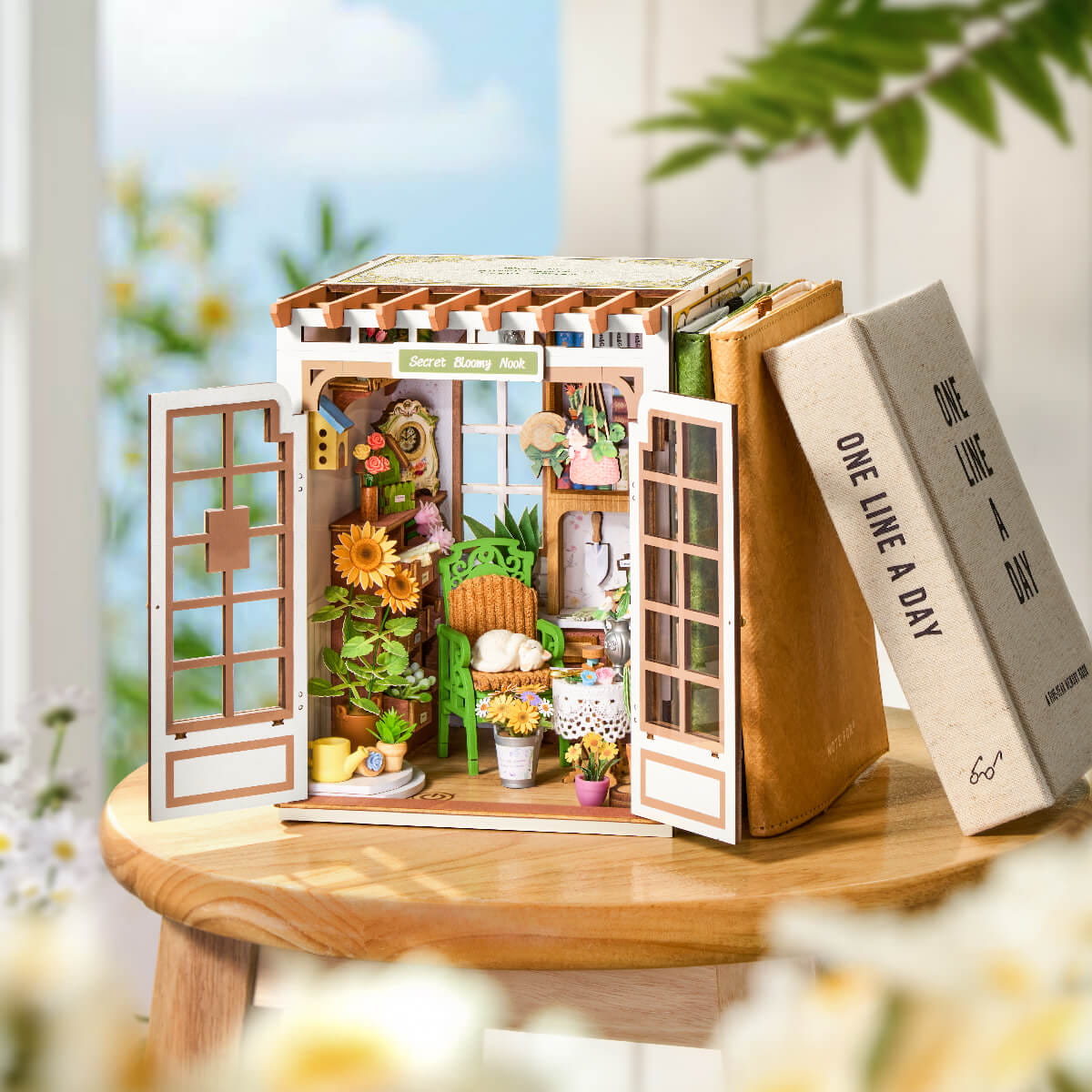 Miniature wooden house model with open doors on a wooden surface, blurred natural background