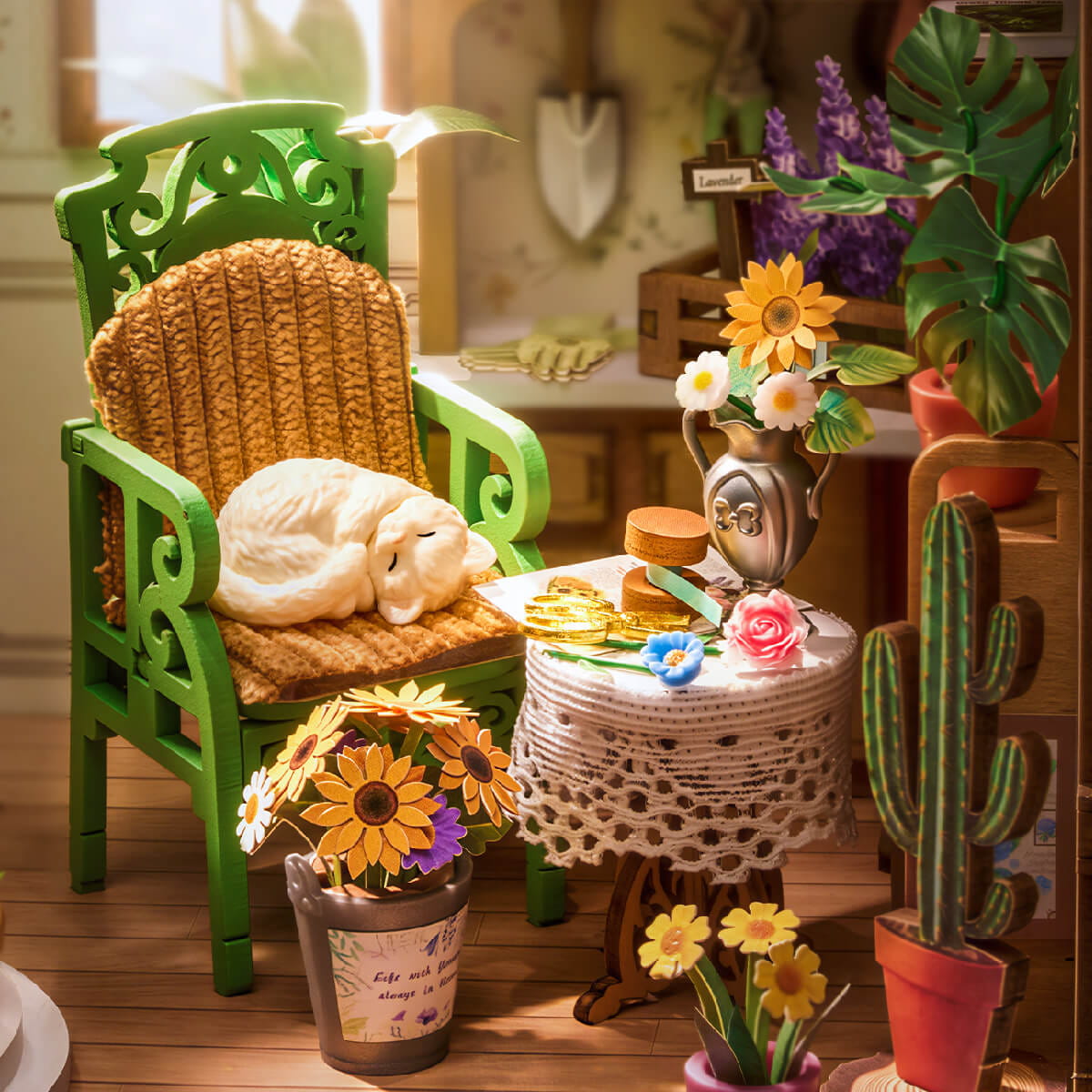 Miniature garden scene with a green chair, plants, and decorative items on a wooden floor.