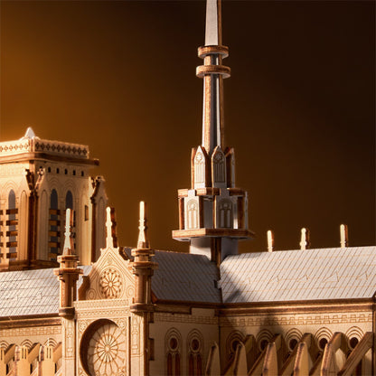 Close-up of a detailed architectural model with a spire against a dark background