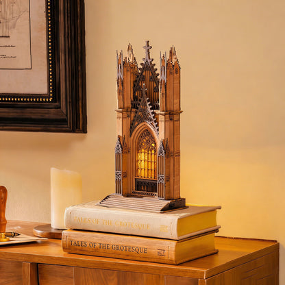 Gothic architecture model on top of books with a warm glow in a cozy room.