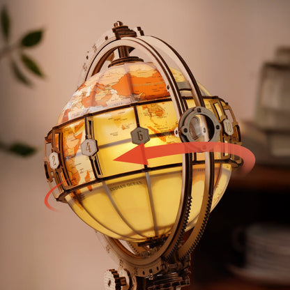 Decorative globe with world map and glowing interior, surrounded by gears.