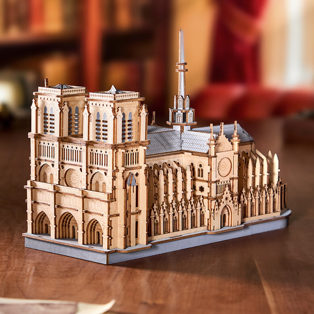 Wooden model of a cathedral on a wooden surface with a blurred background