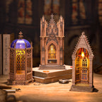 Three gothic-style lanterns on a wooden surface with a blurred background