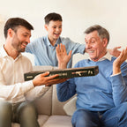 Two men and a boy sitting on a couch, with one man holding a box labeled 'Bolt Action Rifle'.