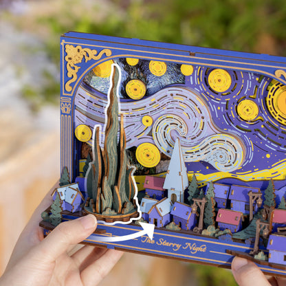 3D puzzle model of 'The Starry Night' by Van Gogh held by a person.