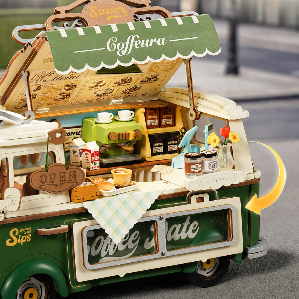 Toy coffee cart with detailed interior and 'Coffeura' sign on a blurred background