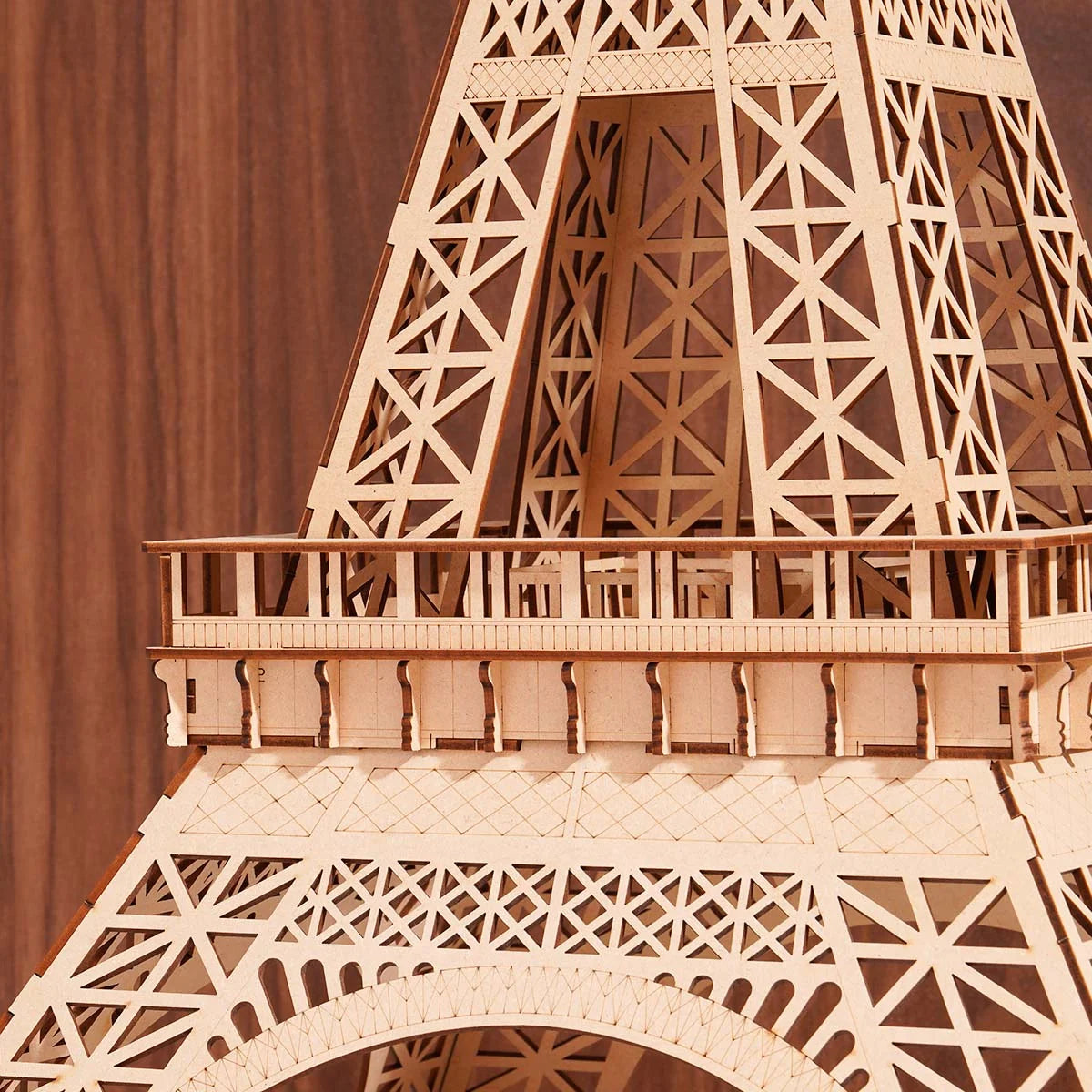 Wooden model of the Eiffel Tower against a brown background