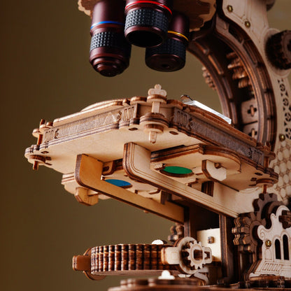 Close-up of a wooden mechanical model with intricate details on a brown background