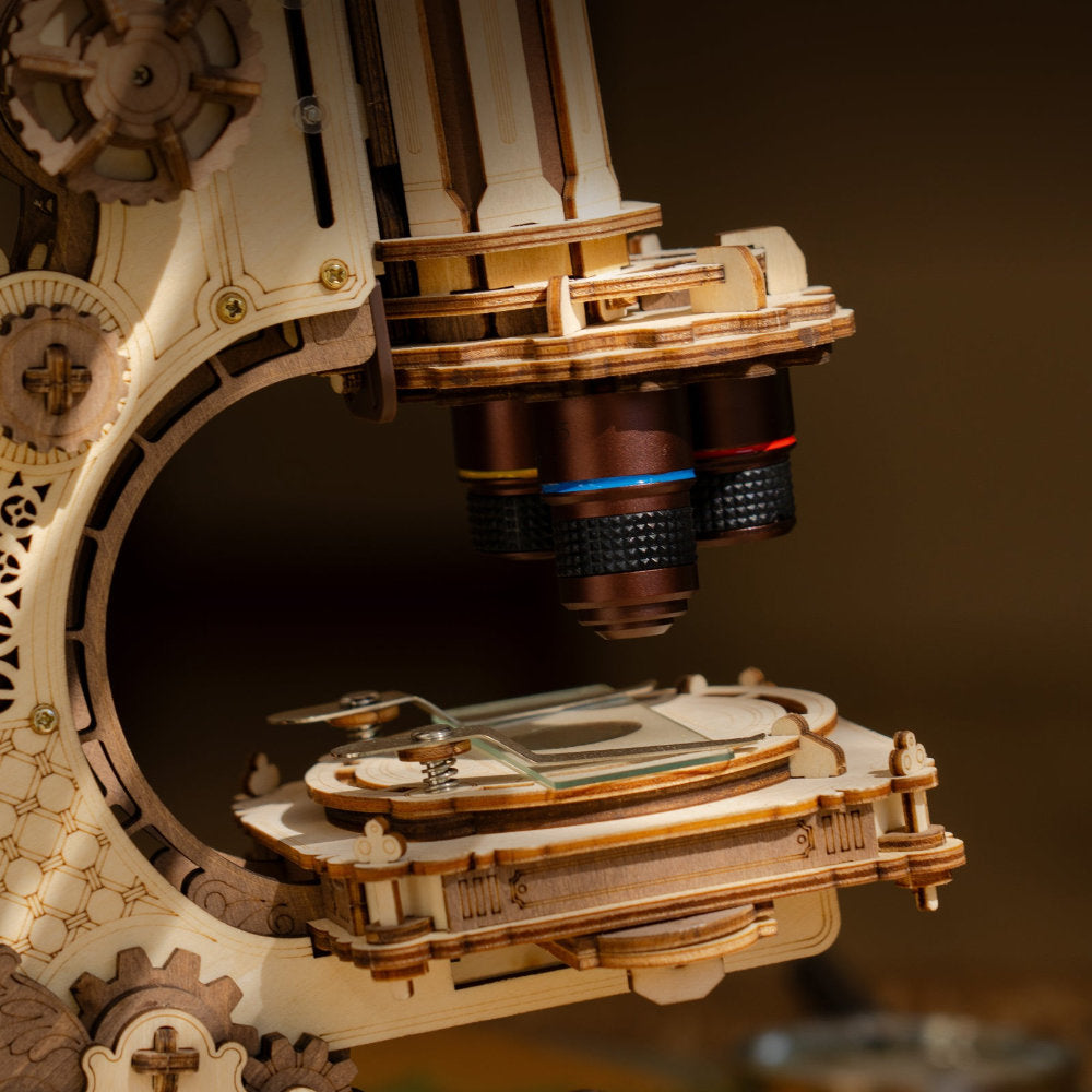 Close-up of a mechanical model resembling a microscope with intricate details.