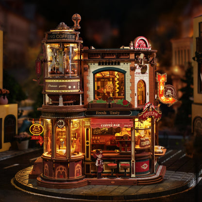 Detailed model of a coffee shop with illuminated signs and a person standing in front.