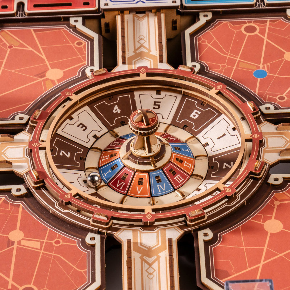 Close-up of a circular game board or spinner wheel with numbered segments 1 through 6, colored blue, red, orange, and brown, surrounded by decorative geometric panels in warm orange, cream, and gold tones.