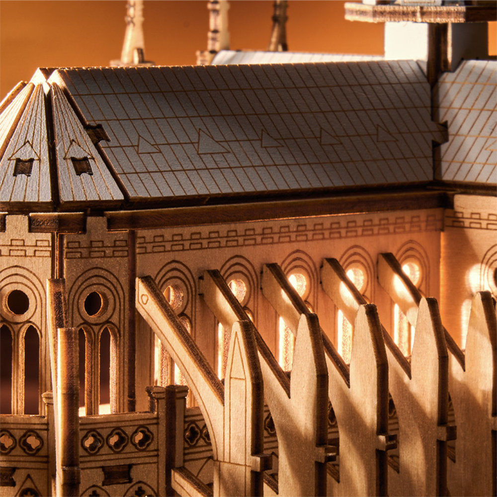 Close-up of a wooden model of a cathedral with detailed architecture.