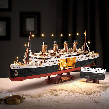 Model of the Titanic on a table with decorative lights in the background
