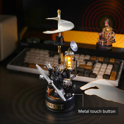 Mechanical model with glowing light on a desk with keyboard in the background