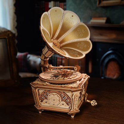 Decorative wooden gramophone on a wooden surface with a blurred background