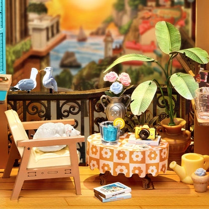 Miniature outdoor setting with a table, chairs, and decorative elements.