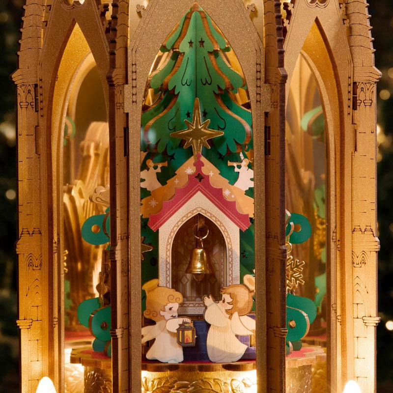 Wooden-Town Angel's Christmas Pyramid 3D wooden puzzle music box – close-up of the inner scene with Christmas tree, bell and angels behind Gothic arches