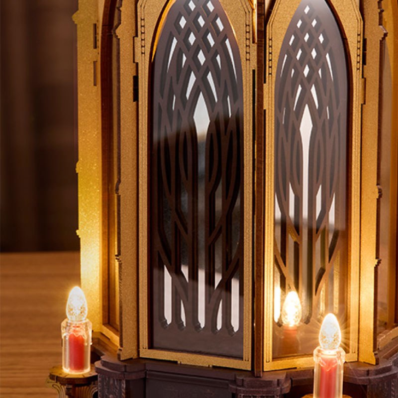 Wooden-Town Angel's Christmas Pyramid 3D wooden puzzle music box – close-up of lattice-cut arched panels with electronic candles at the base