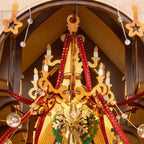 Wooden-Town Caroling Cathedral 3D wooden book nook kit – close-up of the gold chandelier with candles, red ribbons and clear beads