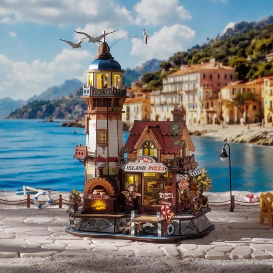Wooden-Town Chillbay Pizzeria Music Box Kit – displayed by the sea with seagulls above the lighthouse