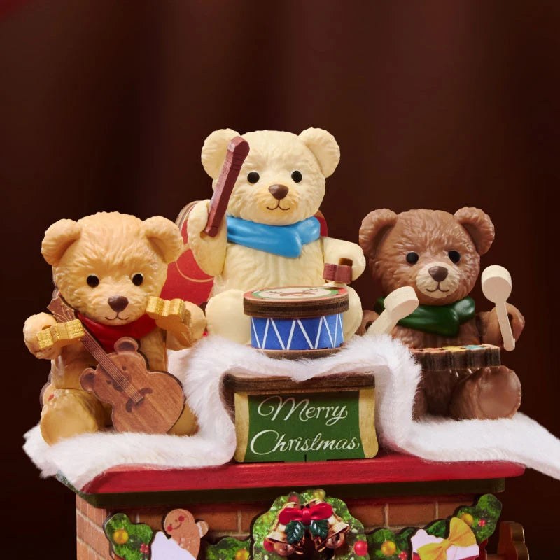 Wooden-Town Fireside Music Night 3D wooden puzzle music box – close-up of three teddy bear musicians on the snowy mantel above a Merry Christmas sign