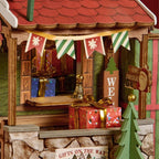 Wooden-Town Polaris Post DIY miniature house kit – close-up of the gift window with bunting and wrapped presents