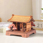 Wooden-Town Sacred Sakura Temple 3D Puzzle Kit – on a desk next to books